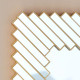 Oglinda decorativa perete cu rama geometrica aurie, 74x55 cm, design modern elegant cu elemente geometrice dispuse diagonal